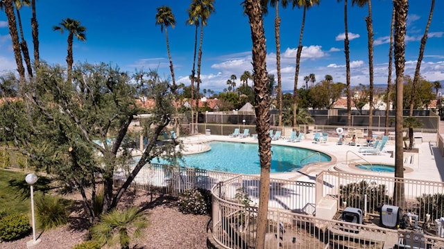 view of pool with a community hot tub and a patio area