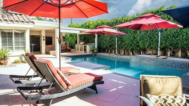 view of pool featuring a patio and area for grilling