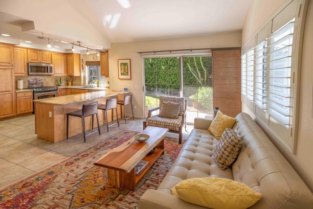 living room featuring light tile patterned flooring and high vaulted ceiling