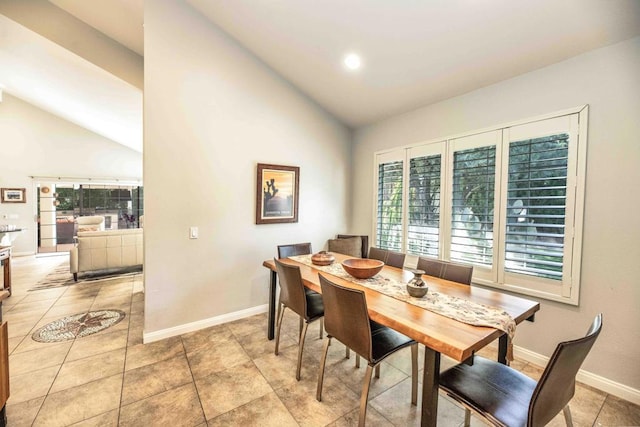 tiled dining area with lofted ceiling