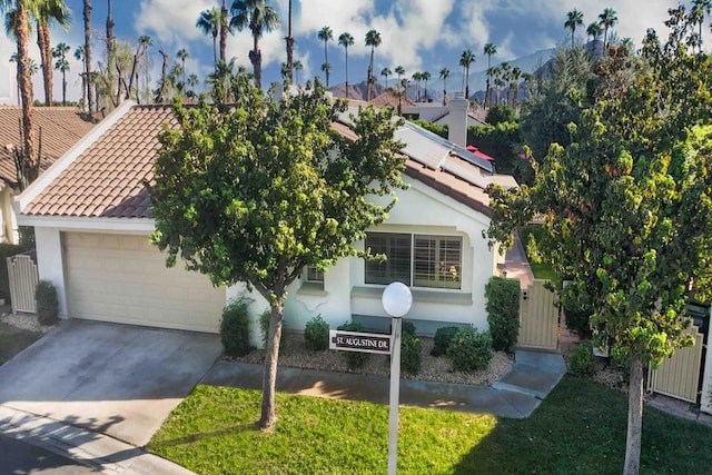 view of property hidden behind natural elements featuring a garage