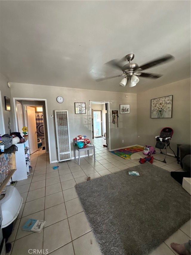 living room with ceiling fan and light tile patterned floors