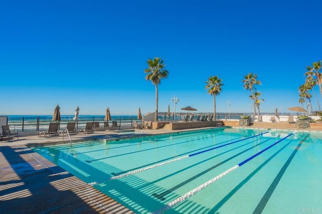 view of swimming pool featuring a water view