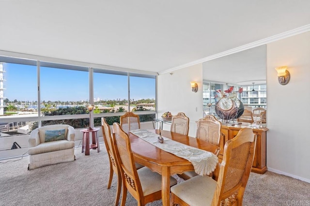 carpeted dining space featuring a wall of windows and ornamental molding