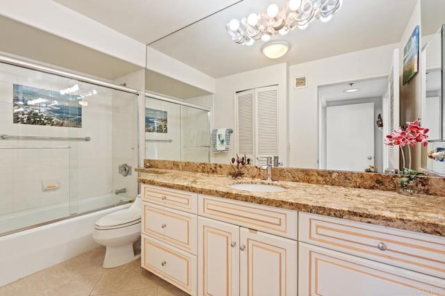 full bathroom featuring vanity, combined bath / shower with glass door, toilet, and tile patterned flooring