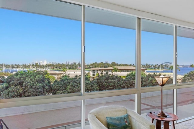 unfurnished sunroom with a water view and plenty of natural light