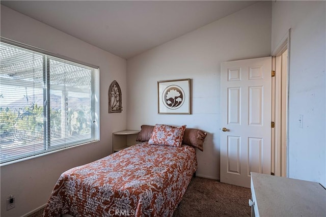 carpeted bedroom featuring vaulted ceiling and multiple windows