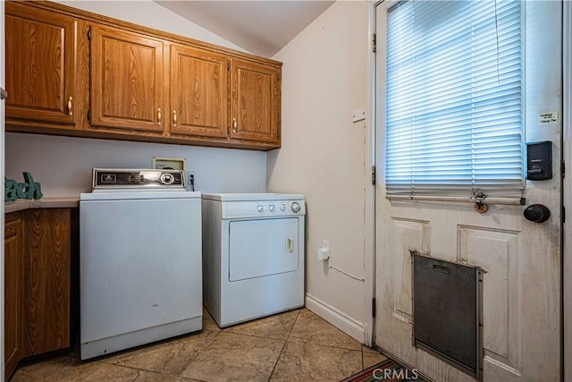 washroom with cabinets and washer and dryer