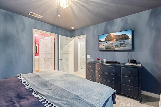 bedroom featuring light colored carpet and ensuite bath