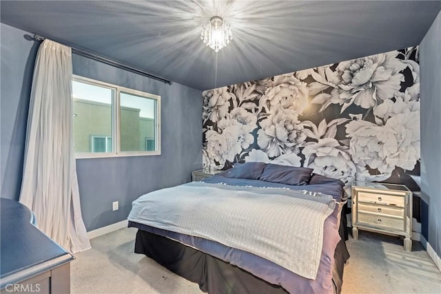 bedroom featuring light carpet and an inviting chandelier