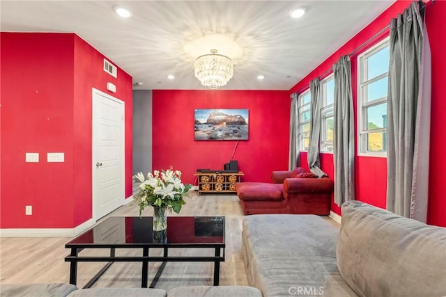 living room with a chandelier and wood-type flooring