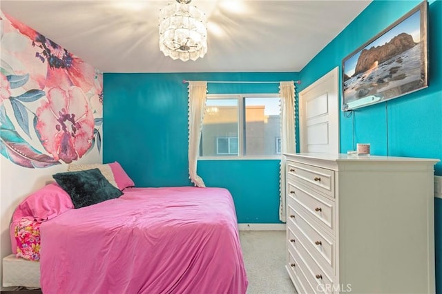 carpeted bedroom featuring an inviting chandelier