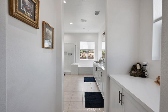 bathroom featuring tile patterned floors, separate shower and tub, and vanity