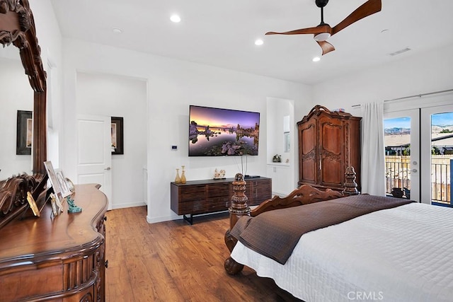 bedroom featuring ceiling fan, light hardwood / wood-style floors, access to exterior, and french doors