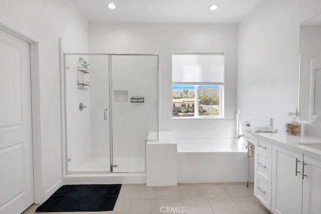 bathroom featuring tile patterned floors, vanity, and independent shower and bath