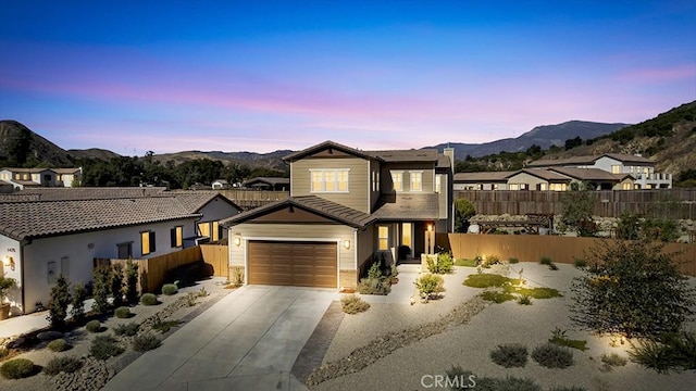 view of front of property featuring a mountain view and a garage