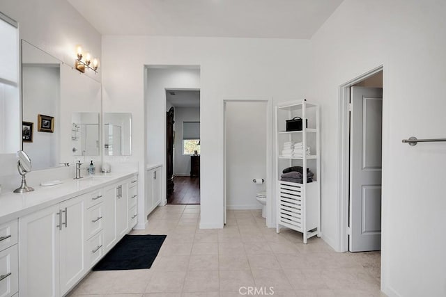 bathroom featuring tile patterned flooring, vanity, and toilet