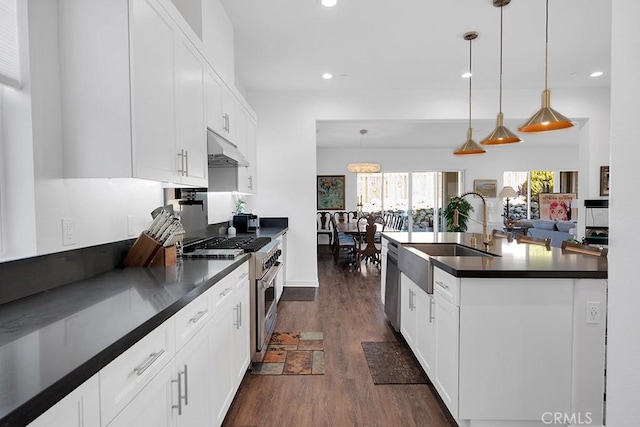 kitchen featuring appliances with stainless steel finishes, white cabinetry, pendant lighting, and sink