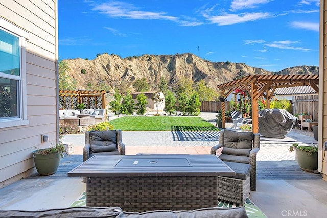 view of patio with a mountain view, a pergola, grilling area, and an outdoor hangout area