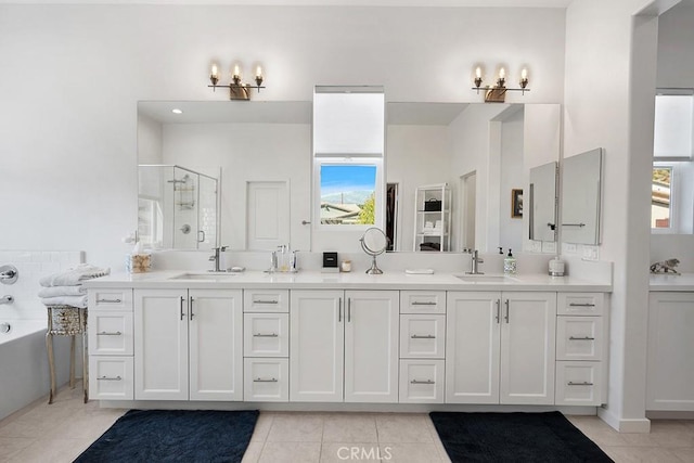 bathroom with tile patterned flooring, plenty of natural light, a shower with door, and vanity