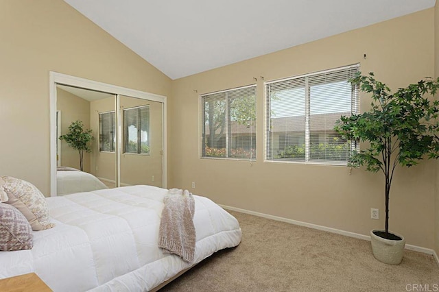 bedroom featuring lofted ceiling, light colored carpet, and a closet