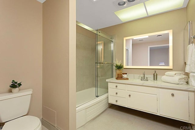 full bathroom with tile patterned flooring, bath / shower combo with glass door, vanity, and toilet