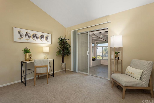 living area featuring vaulted ceiling and carpet flooring