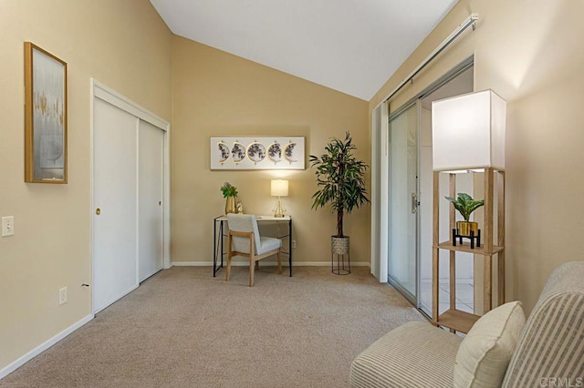 sitting room featuring light colored carpet and vaulted ceiling