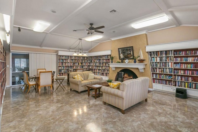 sitting room featuring lofted ceiling, visible vents, a ceiling fan, a large fireplace, and wall of books