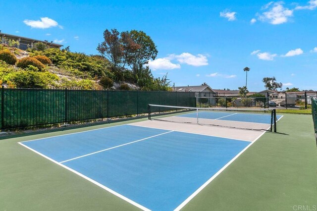 view of sport court featuring fence