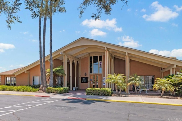 view of property featuring uncovered parking