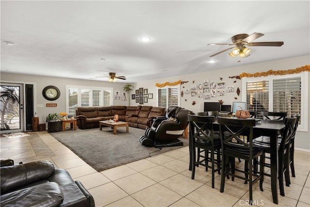 dining space featuring light tile patterned floors and ceiling fan