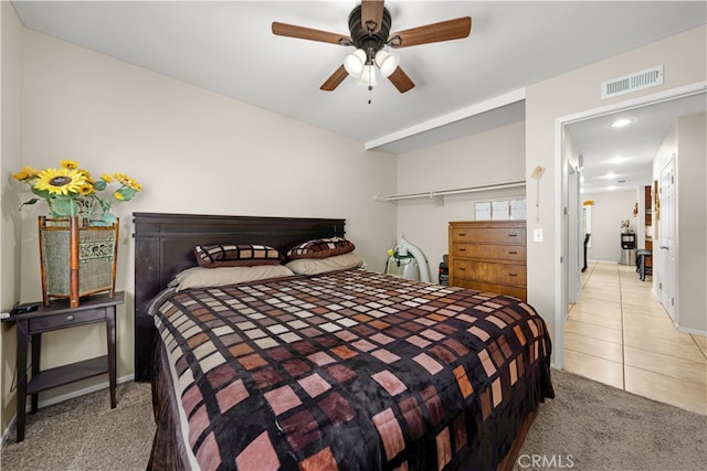 bedroom featuring ceiling fan and light carpet