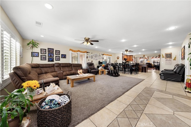 tiled living room with ceiling fan