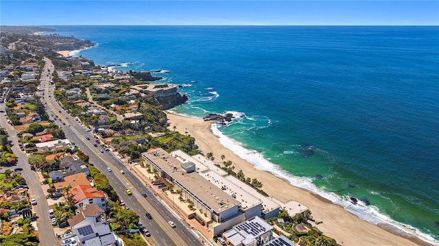 birds eye view of property featuring a water view and a beach view