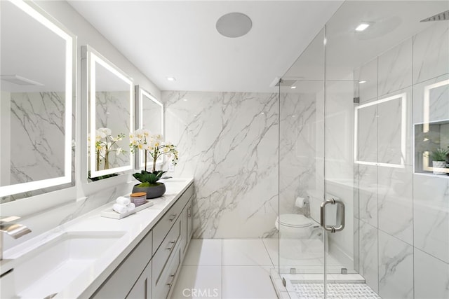 bathroom featuring vanity, a healthy amount of sunlight, toilet, and a shower with shower door