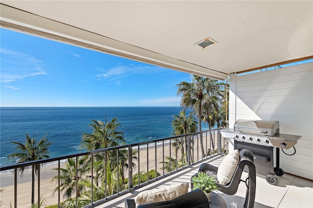 balcony featuring a grill, a water view, and a view of the beach