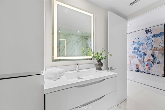 bathroom with tile patterned flooring and vanity