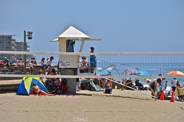 view of playground with a view of the beach and a water view