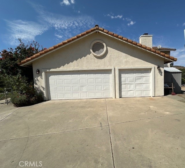 view of side of home featuring a garage