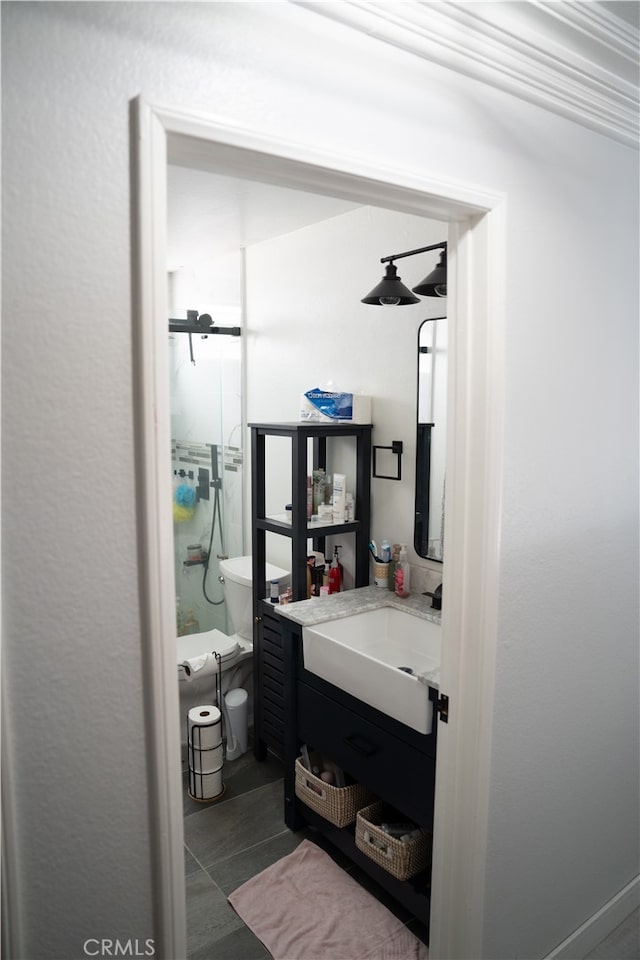 bathroom with vanity, walk in shower, and tile patterned flooring