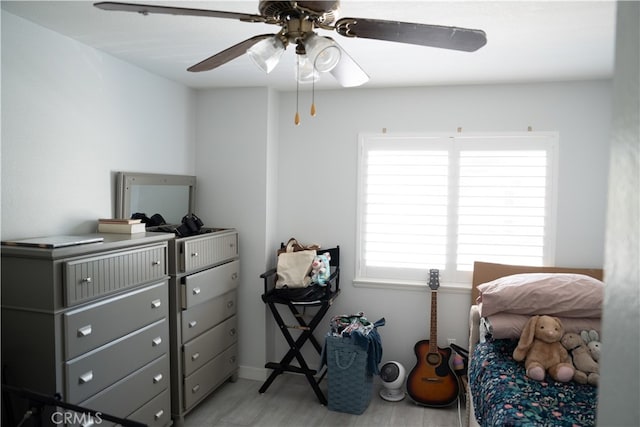 bedroom with light hardwood / wood-style floors and ceiling fan