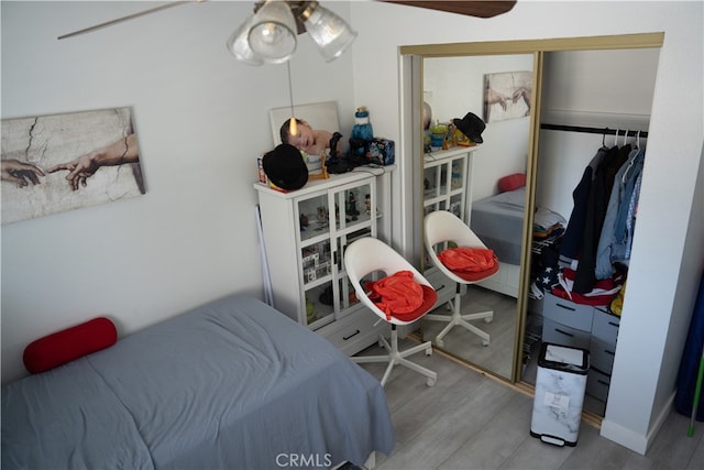 bedroom featuring a closet, ceiling fan, and light wood-type flooring