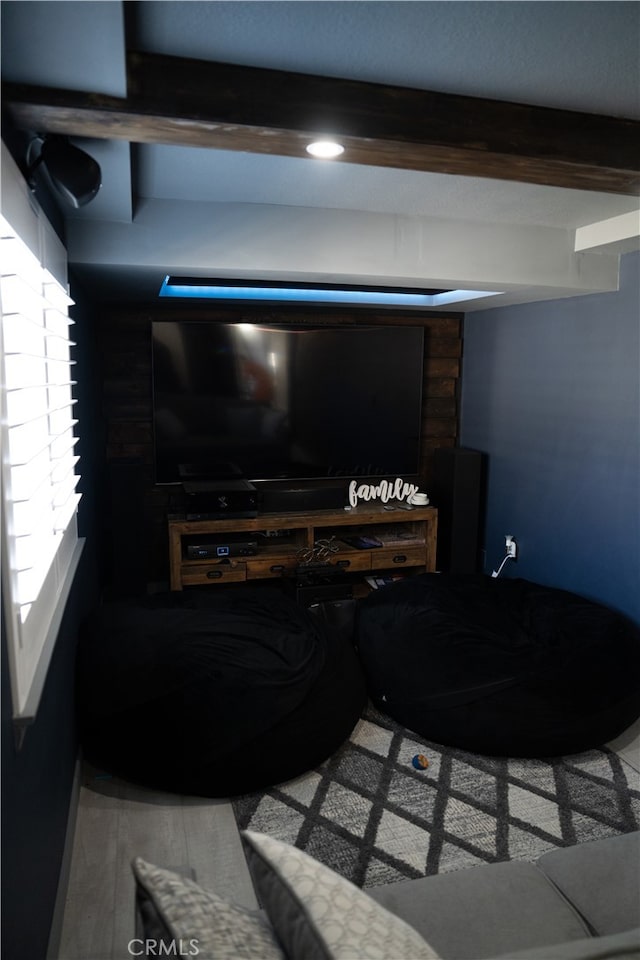 living room featuring hardwood / wood-style floors and beam ceiling