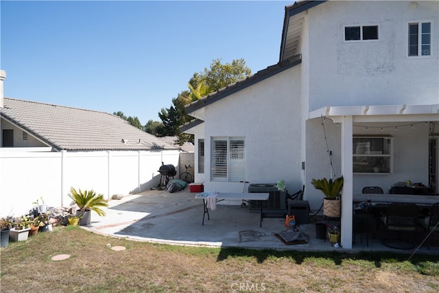 back of property featuring cooling unit and a patio