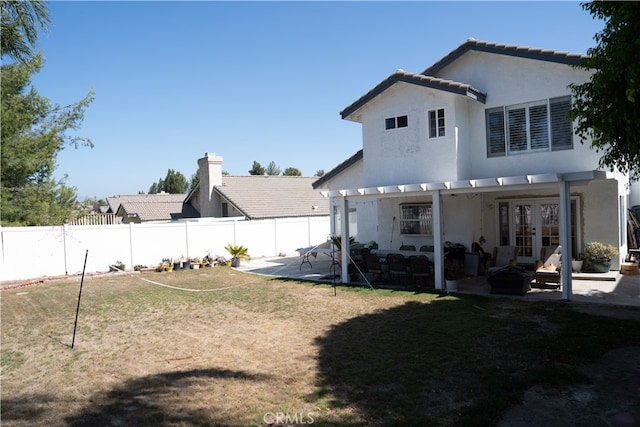 back of house with a patio, french doors, and a yard