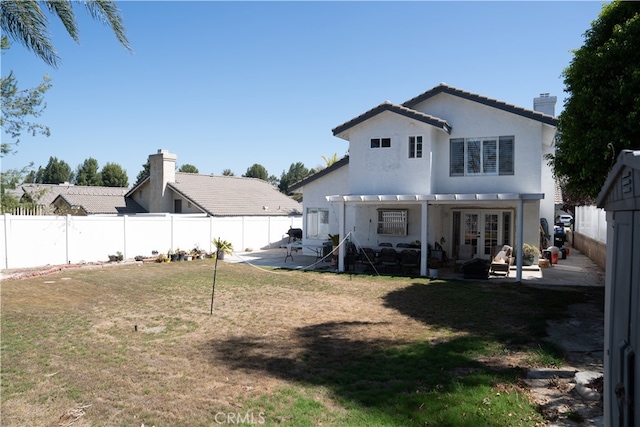 back of property with a patio area, a lawn, and a pergola