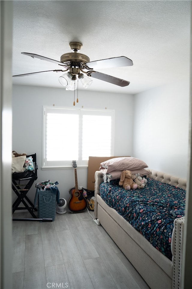 bedroom with hardwood / wood-style floors and ceiling fan