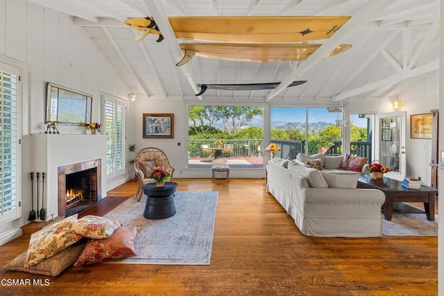 living room featuring hardwood / wood-style floors and vaulted ceiling with beams