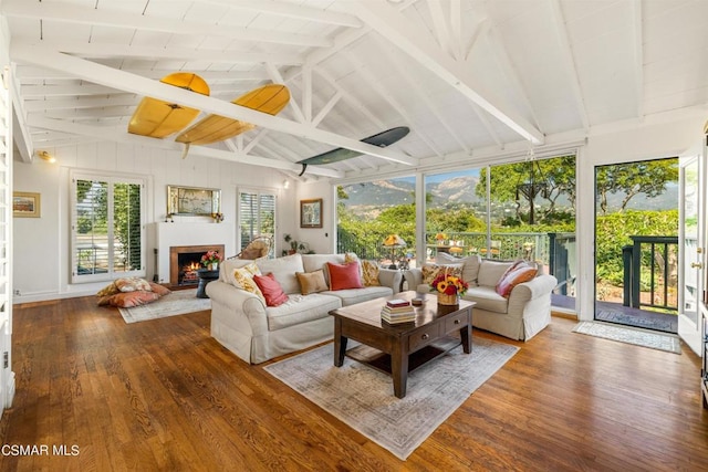 sunroom featuring lofted ceiling with beams and plenty of natural light